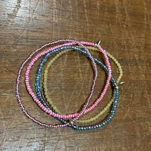 4 itsy bracelets. 2 pinks 1 pineapple 1 blue Rachel Lynn by Corri Lynn